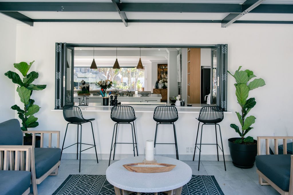 Bi-fold doors connecting bar to outdoor lounge