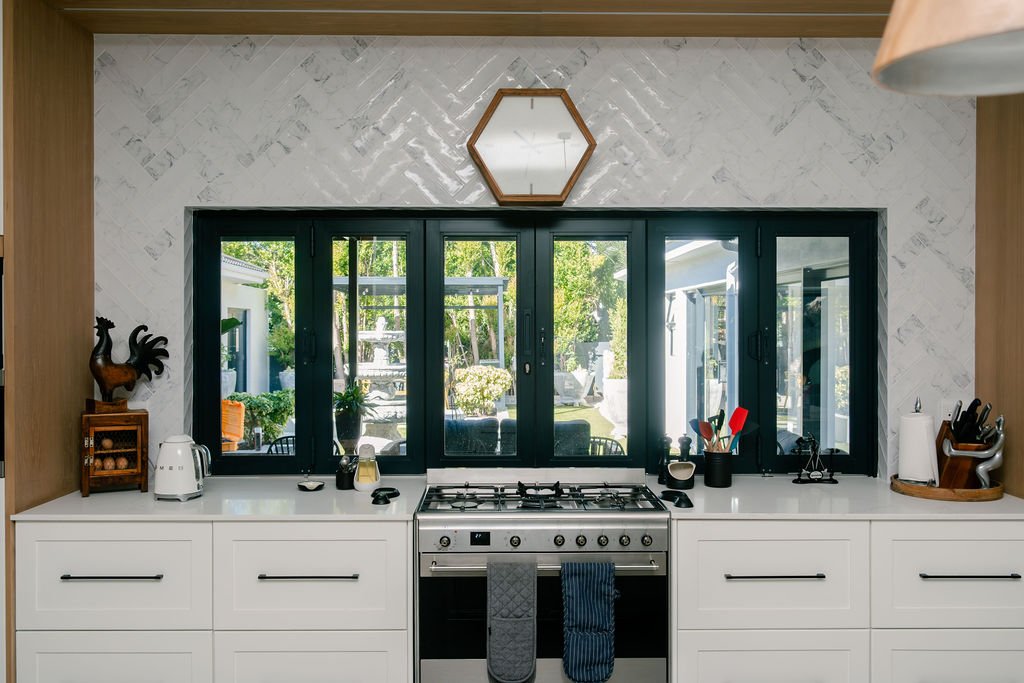 Bi-fold glass doors above gas range