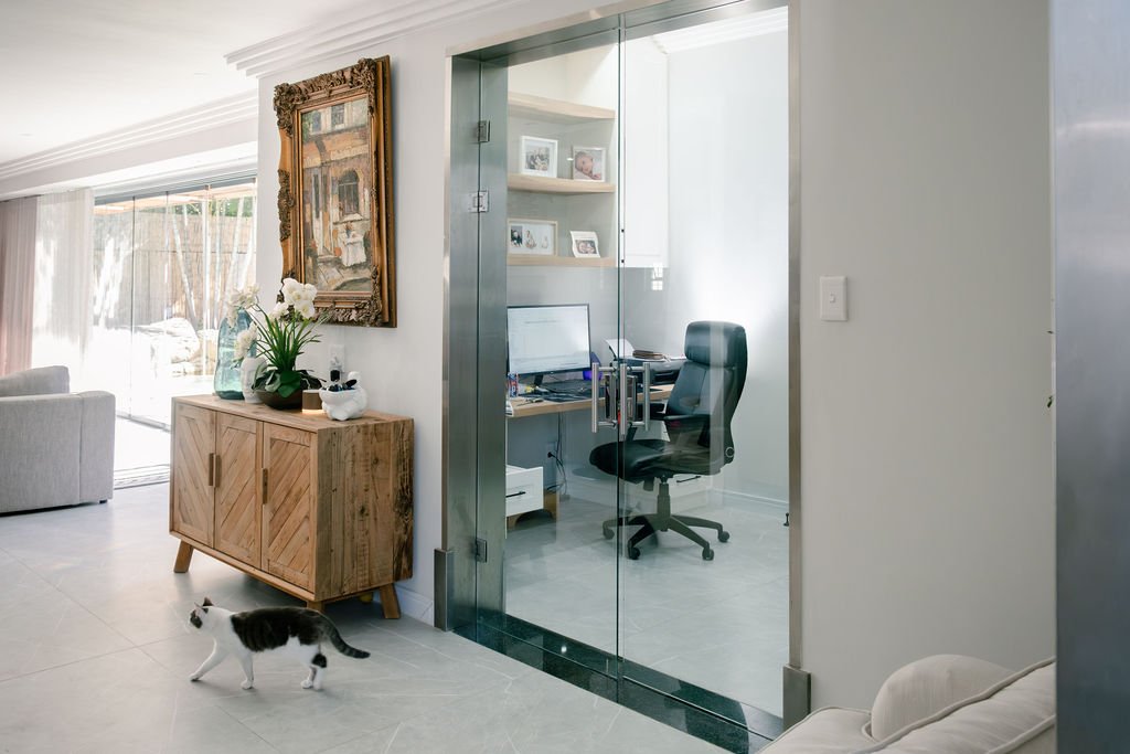 Frameless glass partition enclosing home office