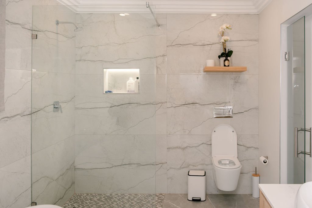 Frameless glass shower enclosure