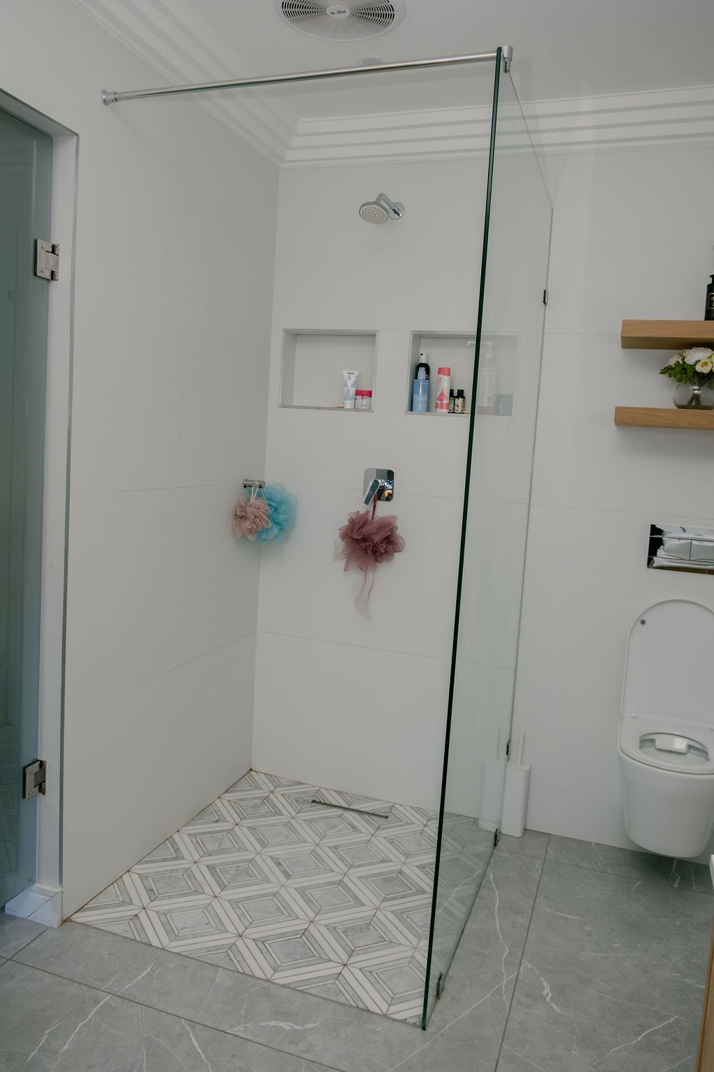 Frameless glass shower enclosure