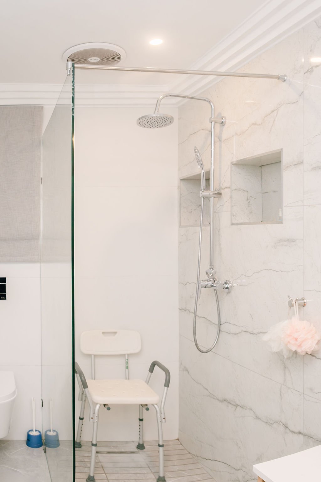 Frameless glass shower enclosure