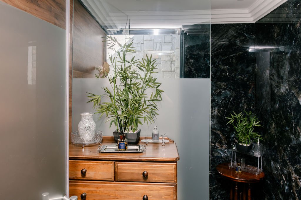Frameless glass shower enclosure
